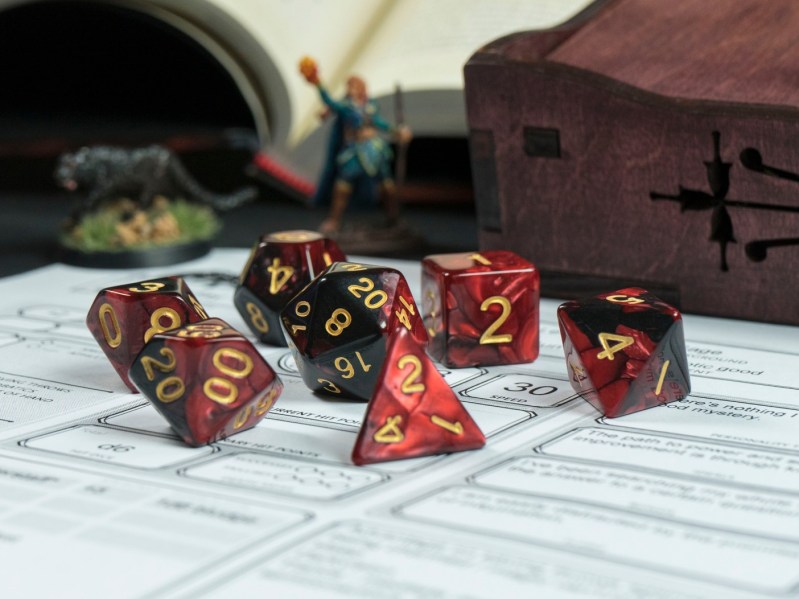 a game board with Dungeons and Dragons dice on top