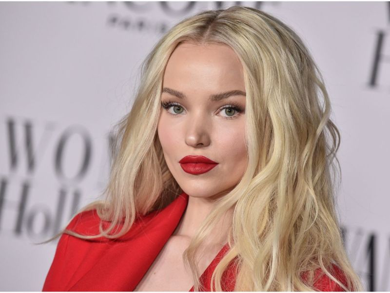 Dove Cameron wearing a red blazer and red lipstick