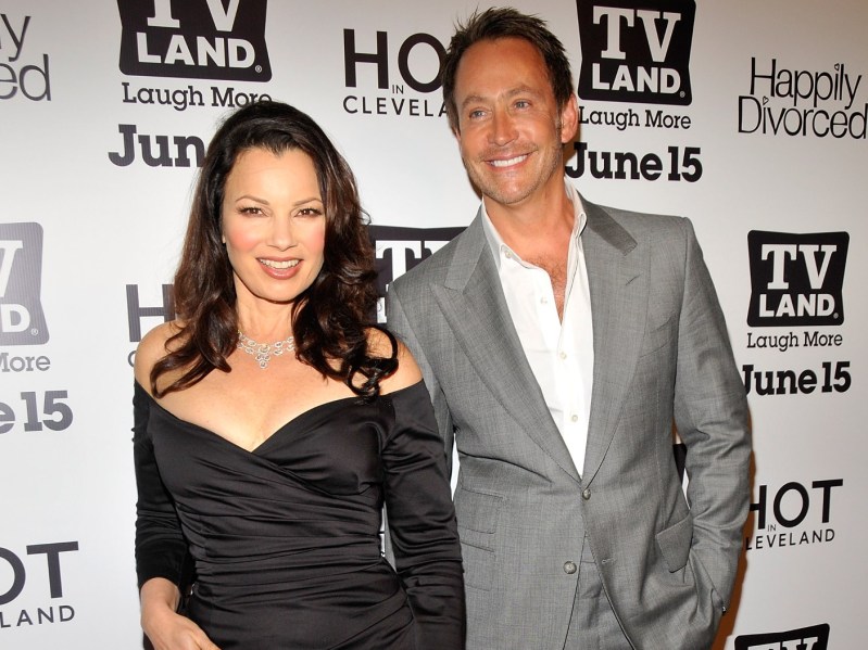 Fran Drescher (L) in black dress standing next to Peter Marc Jacobson, who is wearing a gray suit jacket over a white dress shirt
