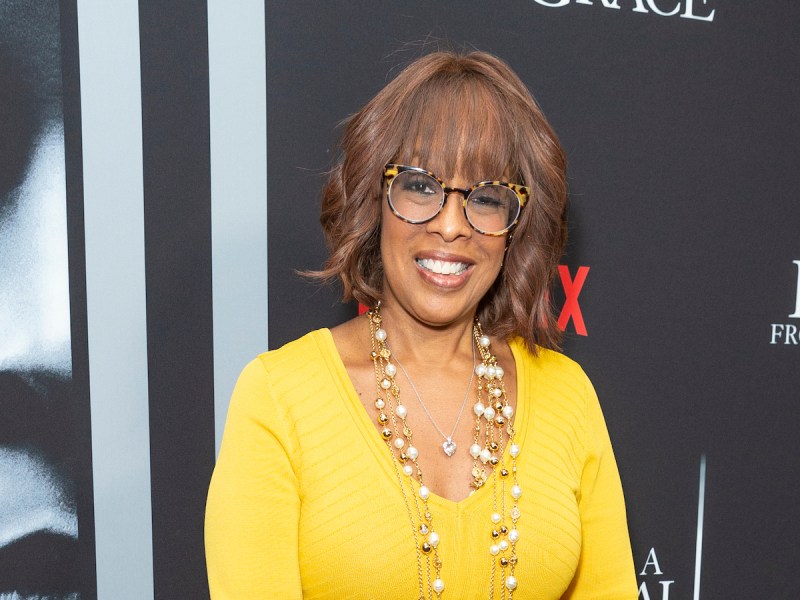 2020 photo of Gayle King smiling in a yellow dress