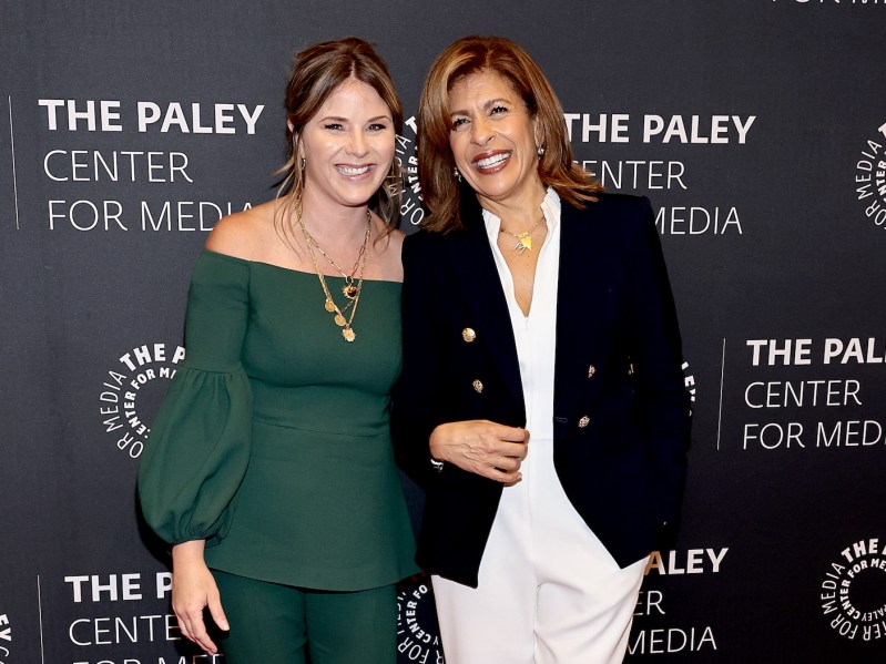 Jenna Bush Hager in a green dress smiling with Hoda Kotb in a black jacket