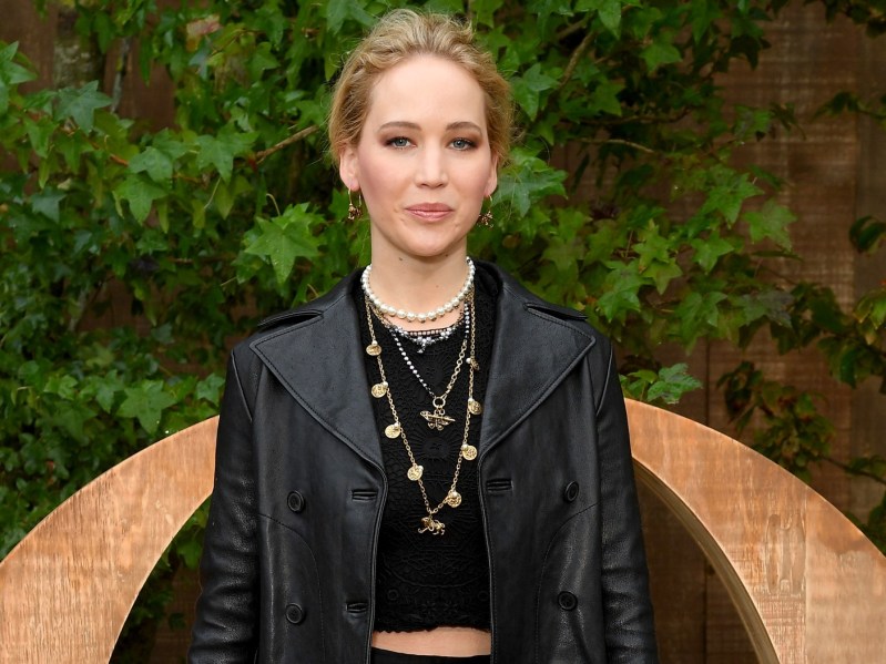Jennifer Lawrence poses in black two-piece outfit with black leather jacket