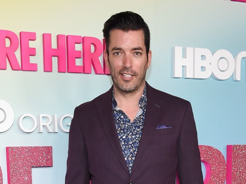 Jonathan Scott smiling in a blue shirt and maroon jacket