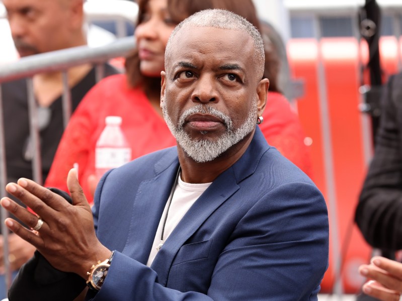 Levar Burton claps in navy blue suit