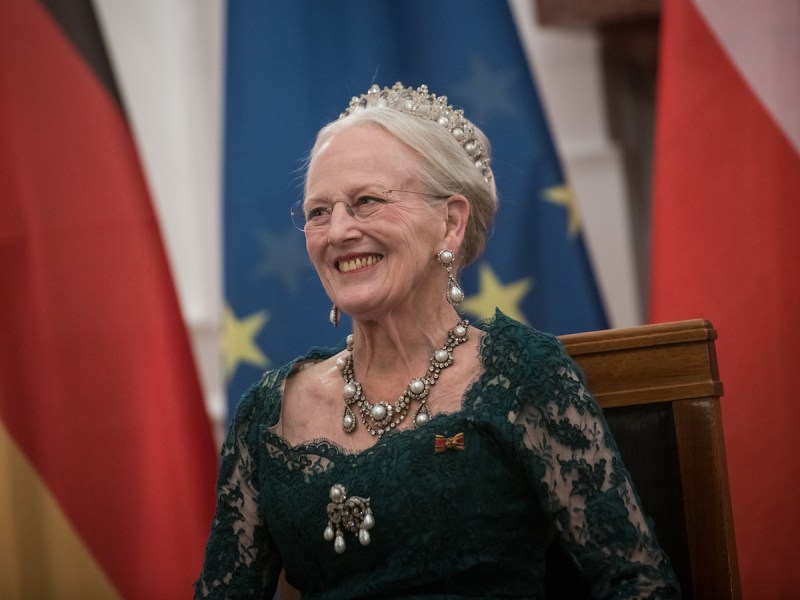 Queen Margrethe of Denmark smiles in a green dress