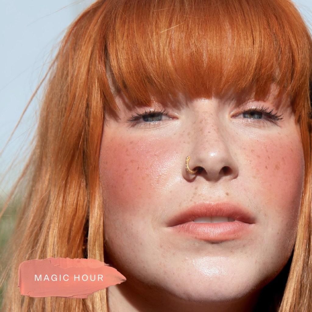 a red haired model wears Tower 28 Beach Please blush in magic hour