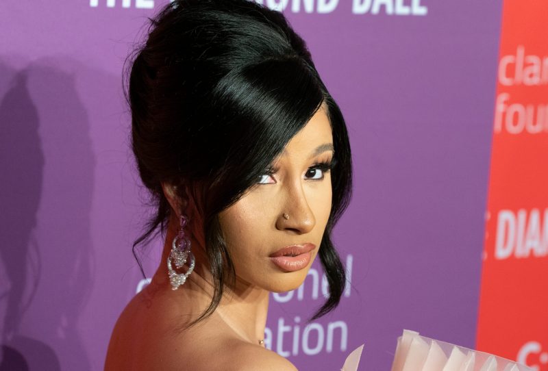 Cardi B with a shiny updo at a 2019 red carpet event.