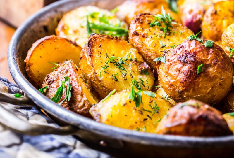 A pan full of crispy skinned roasted potatoes.