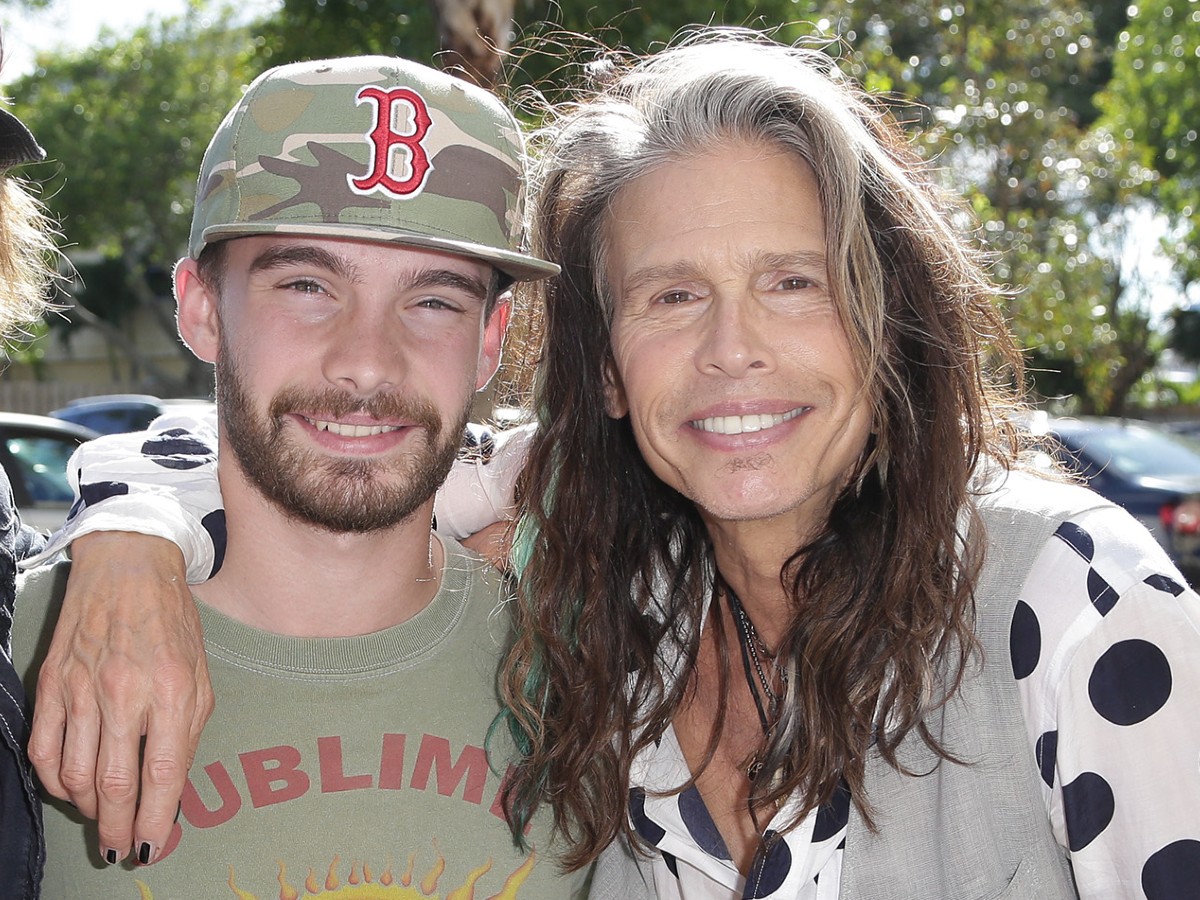 Steven Tyler (R) and his son smiling in a close-up photo