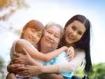 3 generation photo of 3 women hugging and smiling outside