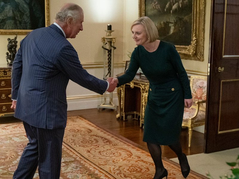 King Charles on the left, shaking hands with PM Liz Truss on the right.