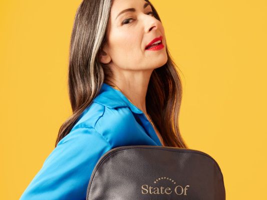 Stacy London poses with a State of Menopause bag