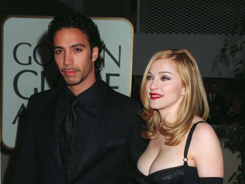 1997 photo of Carlos Leon in a black suit with Madonna in a black dress in 1997