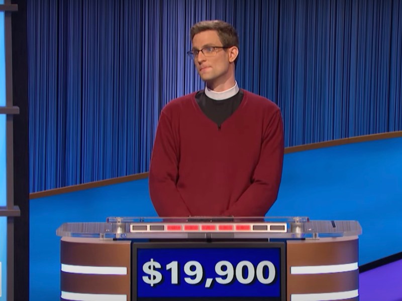 screenshot of David Sibley competing on Jeopardy wearing a clerical collar