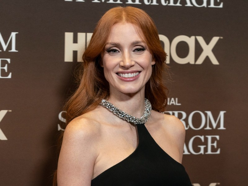 Jessica Chastain smiles in black dress with silver halter top