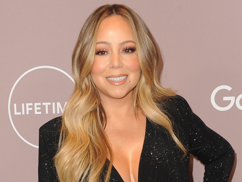 Mariah Carey smiles in black sparkly dress