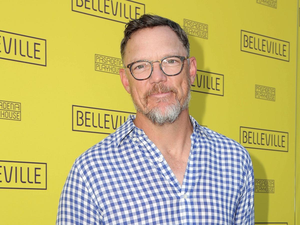 Matthew Lillard smiling in a checkered shirt