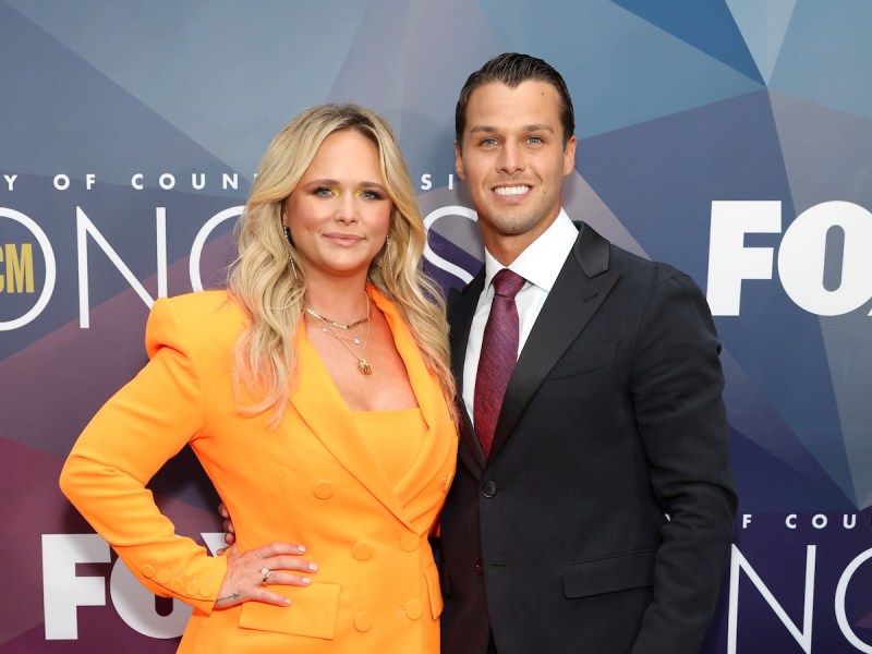 Miranda Lambert in an orange dress with Brendan McLoughlin in a black suit