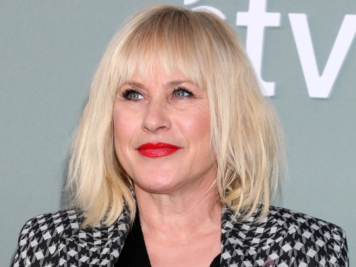 Patricia Arquette smiles in black and white polka-dotted top