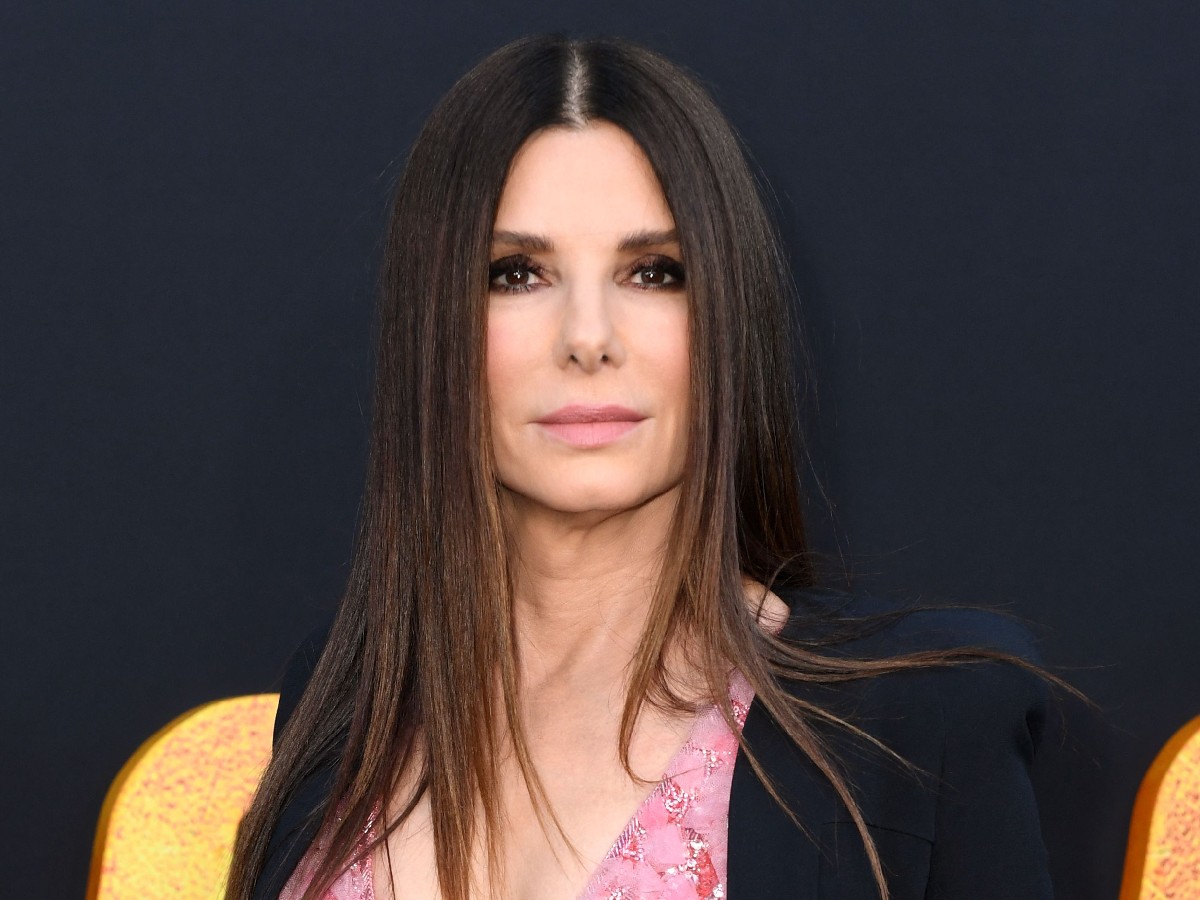 Closeup of Sandra Bullock with straight hair parted in middle