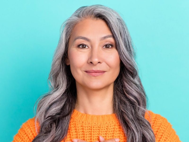 A woman with gray hair and eyebrows