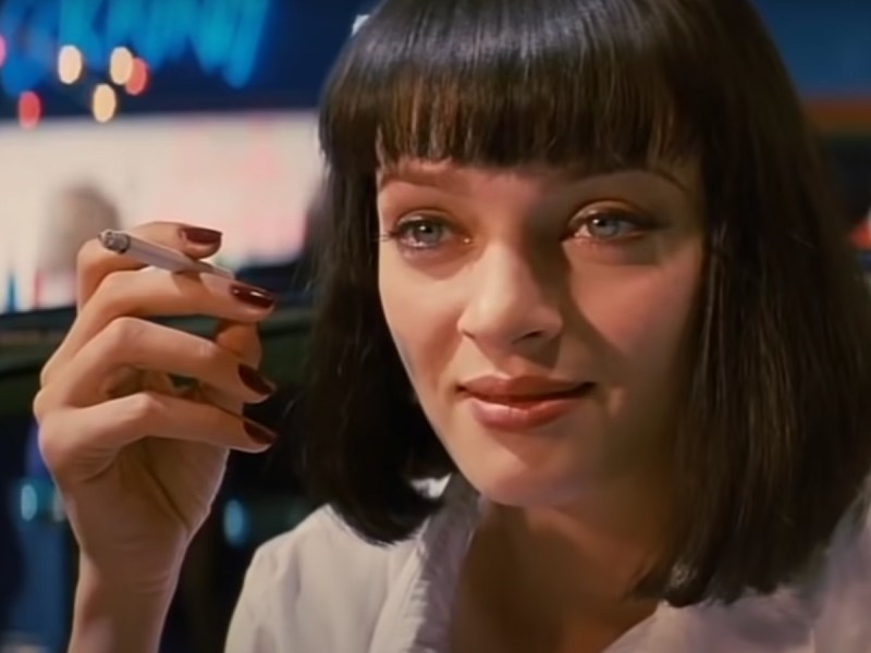 Closeup of Uma Thurman in 'Pulp Fiction' holding cigarette and smiling