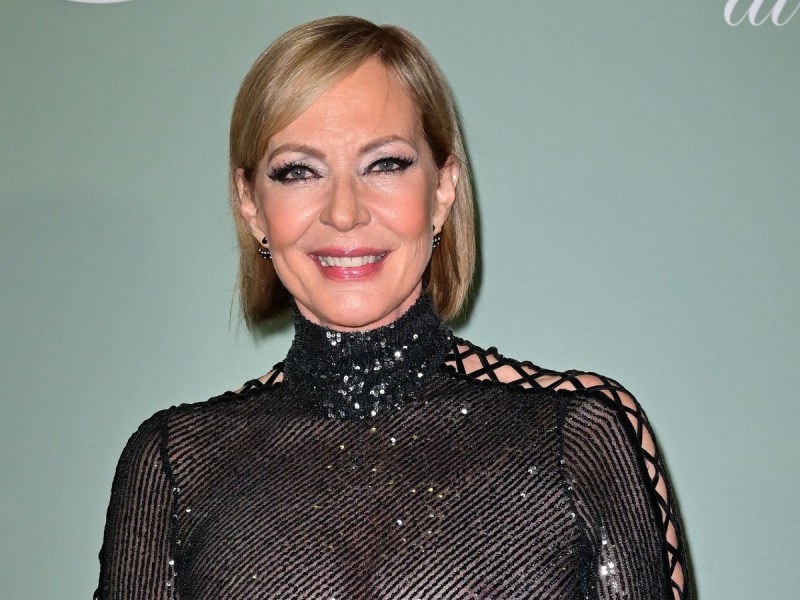 Allison Janney smiles in sheer black dress