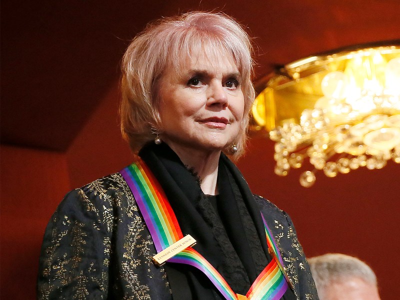 Linda Ronstandt smiling, wearing a Kennedy Center Honors medal around her neck