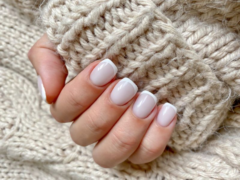 A French manicure with a chunky sweater