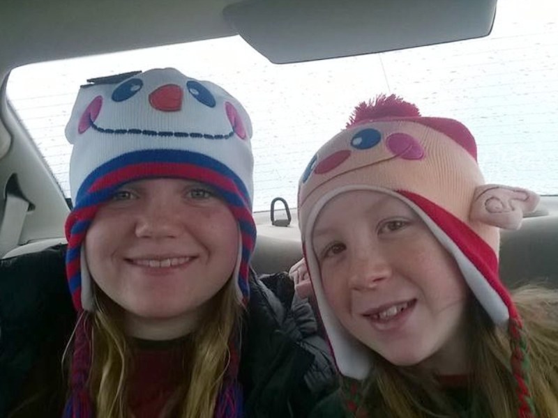 Liberty German (L) and Abigail Williams smiling in warm hats