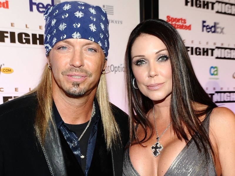 Bret Michaels (L) and Kristi Lynn Gibson smiles in closeup photo against white backdrop