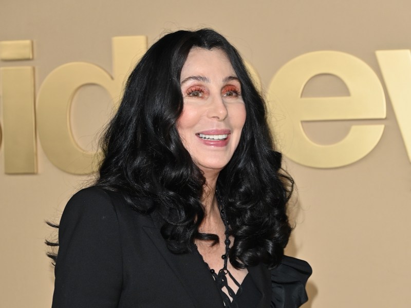 Cher smiling in a black jacket