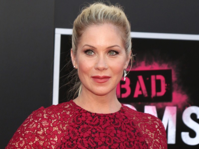 Christina Applegate smiles in red lace dress
