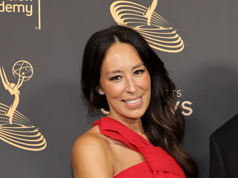 Joanna Gaines smiling in a red dress