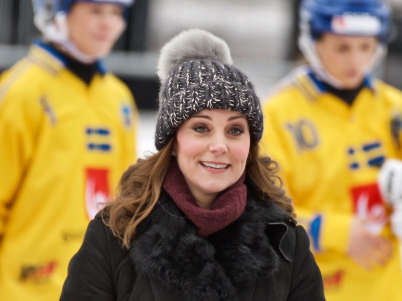 Kate Middleton in a black coat and grey hat in the snow