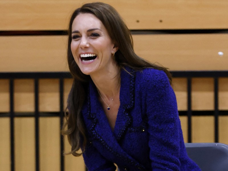 Kate Middleton laughs in royal blue jacket