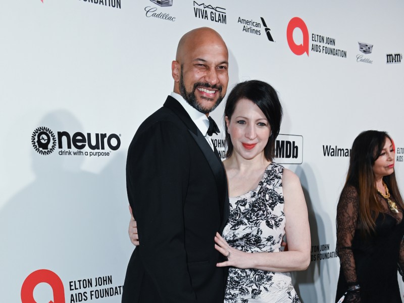 Keegan-Michael Key in a black suit with arm around Elisa Pugilese in a white and black dress