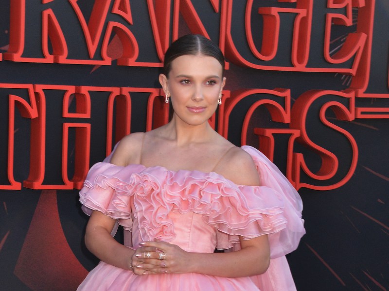 2019 photo of Millie Bobby Brown at the Stranger Things premiere in a pink dress