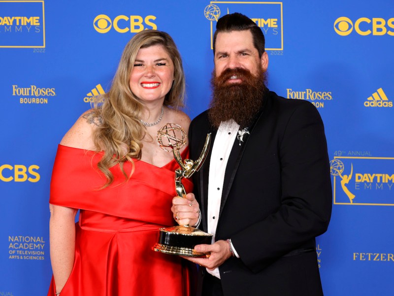 Candis and Andy Meredith holding an Emmy together
