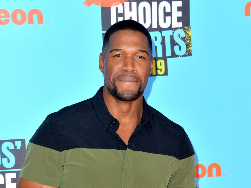 close up of Michael Strahan in a green and black polo shirt