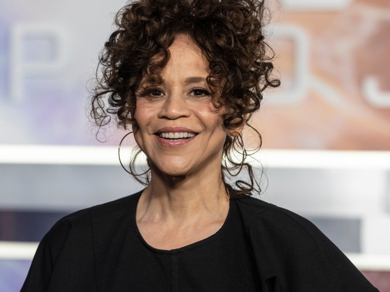Rosie Perez smiles in black top