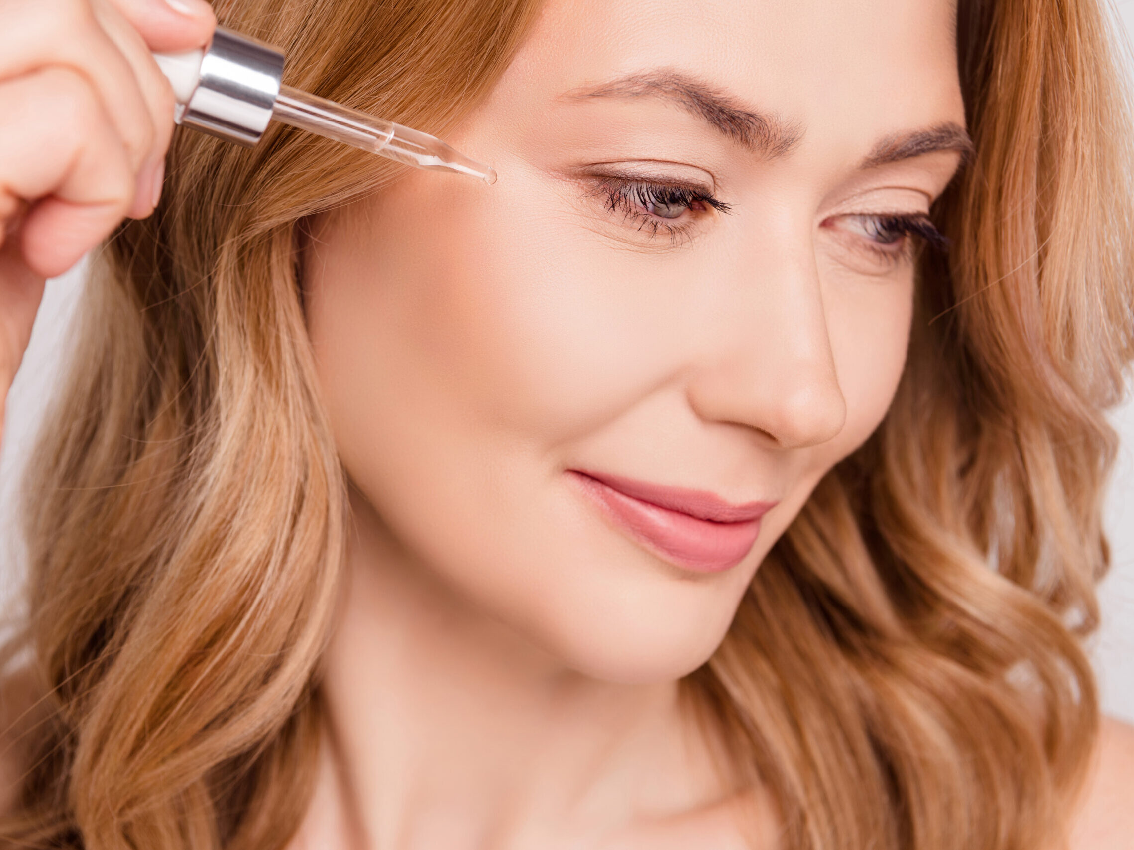 Woman applying face oil