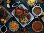 stock photo of a Thanksgiving dinner with turkey, potatoes, gravy, and more