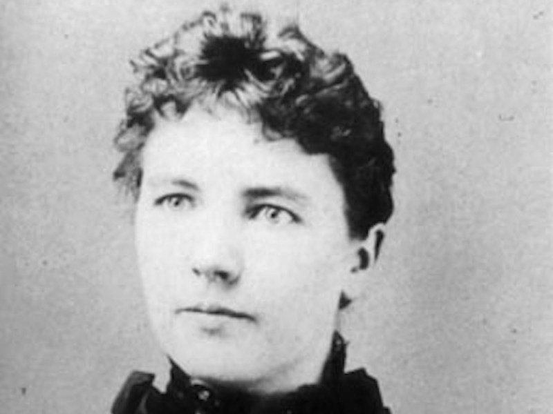 black and white vintage close up photo of Laura Ingalls Wilder's face looking neutral