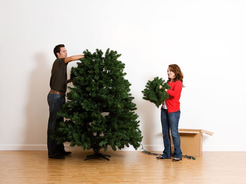 Couple assembling an artificial Christmas tree