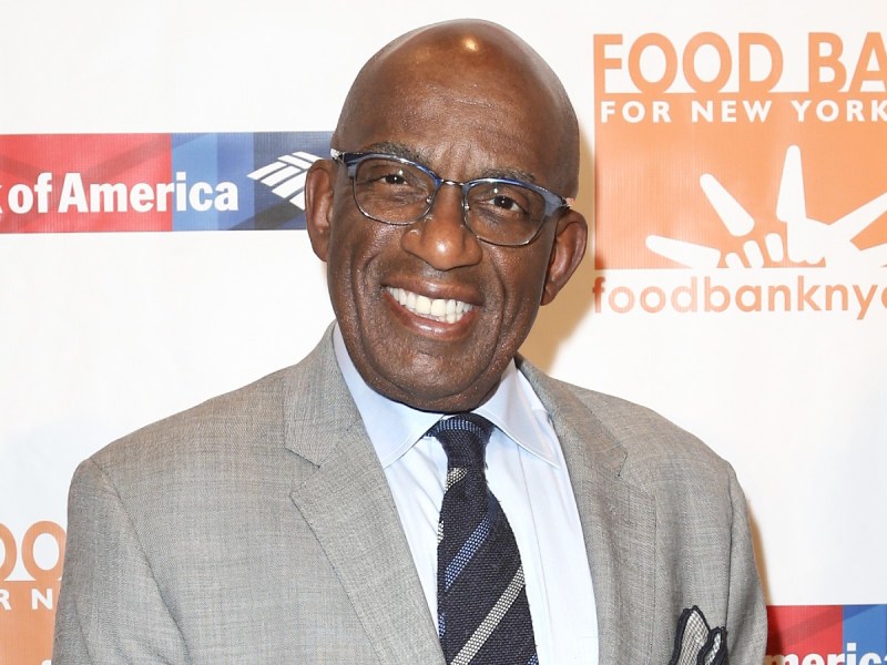 Al Roker smiles in light gray suit and striped tie against white backdrop