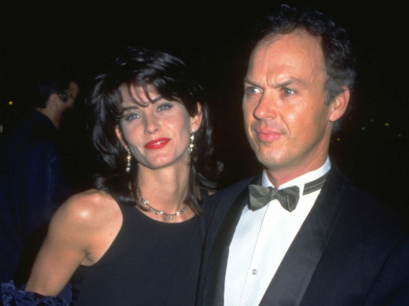 Courteney Cox (L) and Michael Keaton smiling in black outfits