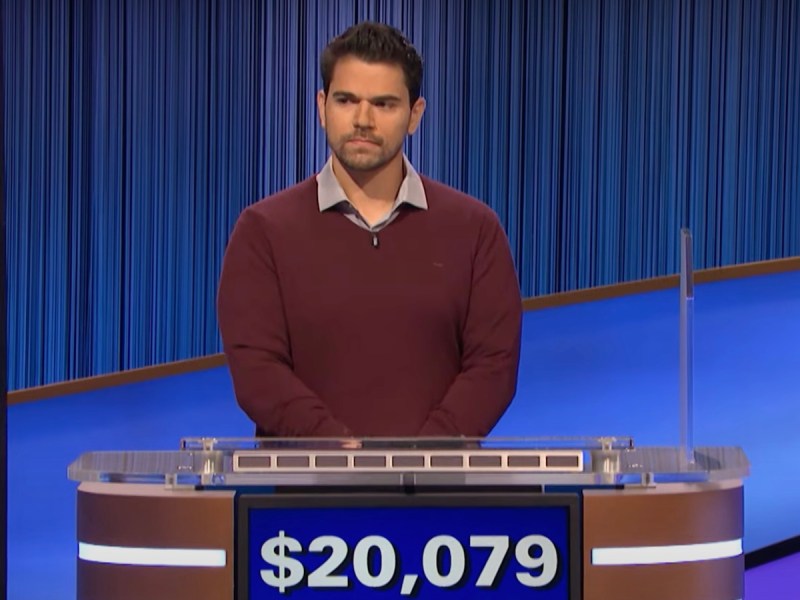 screenshot of Cris Pannullo competing on Jeopardy! looking serious with hands clasped