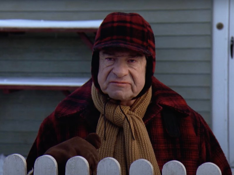 screenshot of Walter Matthau looking cantankerous in Grumpy Old Men dressed in plaid outerwear and a scarf