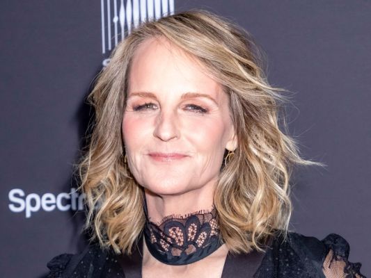 Helen Hunt at a red carpet event wearing a black outfit.